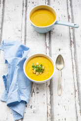 Bowl of sweet potato soup with mango, curcuma and coconut milk, croutons and basil - LVF07733