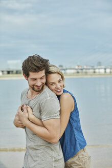 Happy young couple hugging at the riverbank - RORF01673