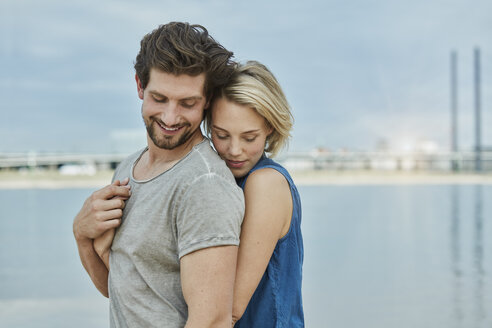 Happy young couple hugging at the riverbank - RORF01675