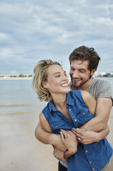 Happy young couple hugging at the riverbank - RORF01679