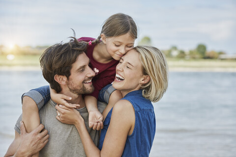 Germany, Duesseldorf, happy family with daughter at Rhine riverbank stock photo