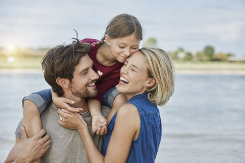 Germany, Duesseldorf, happy family with daughter at Rhine riverbank - RORF01696