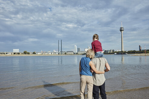 Germany, Duesseldorf, family with daughter standing at Rhine riverbank - RORF01698