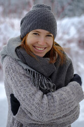Portrait of smiling teenage girl outdoors in winter - LBF02351