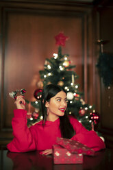 Portrait of smiling teenage girl with Christmas present - ACPF00410