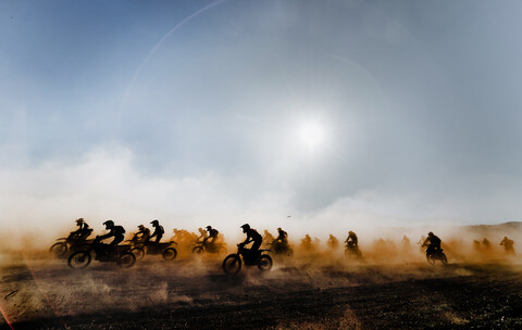 Group of motocross motorcycles coming out in the race stock photo