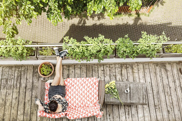 Young woman relaxing on her balcony in summer - PESF01181