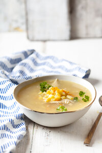 Bowl of homemade chicken stock with potatoes, carrots and parsley - SBDF03885