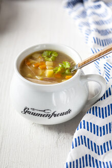 Bowl of homemade chicken stock with potatoes, carrots and parsley - SBDF03888