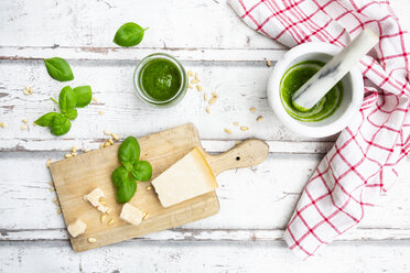 Glass of homemade pesto Genovese, ingredients, mortar and kitchen towel - LVF07751