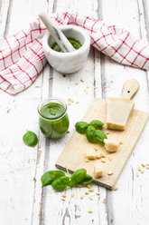Glass of homemade pesto Genovese, ingredients, mortar and kitchen towel - LVF07752