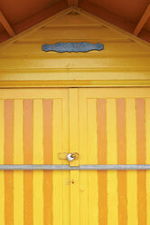 Colorful yellow door of a beach house - IGGF00754