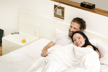 Affectionate couple cuddling in bed - PESF01217