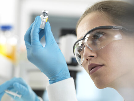 Doctor preparing a vaccine for a patient - ABRF00319