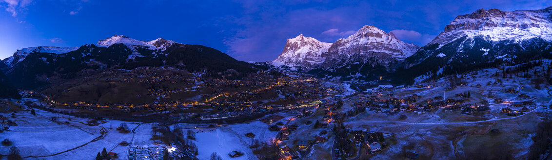 Switzerland, Canton of Bern, Wetterhorn, Grindelwald, townscape at blue hour in winter - AMF06759