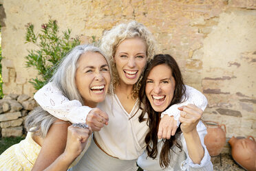 Portrait of three excited women of different age embracing and cheering - PESF01322