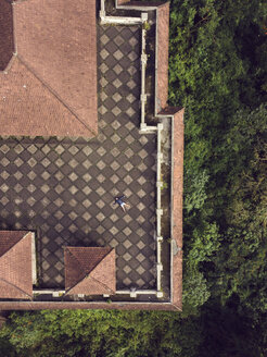 Indonesia, Bali, Aerial view of man on the roof terrace - KNTF02638