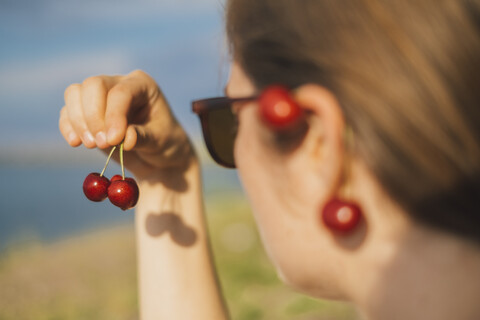 Woman's hand holding cherries stock photo