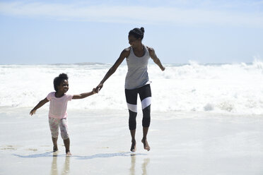 Happy mother and daughter having fun on the beach - ECPF00408