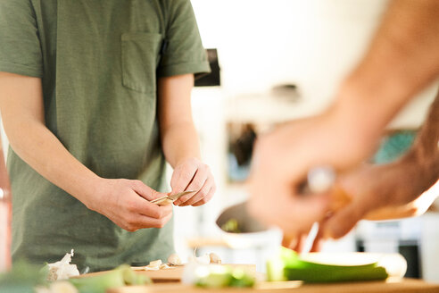 Boy and his father preparing food at kitchen counter, mid section - CUF48511