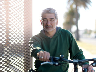 Man with bicycle enjoying sunny day, Melbourne, Victoria, Australia - CUF48574