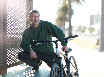 Mann mit Fahrrad an einem sonnigen Tag, Melbourne, Victoria, Australien - CUF48575
