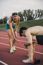 Male and female athlete on tartan track - ACPF00458