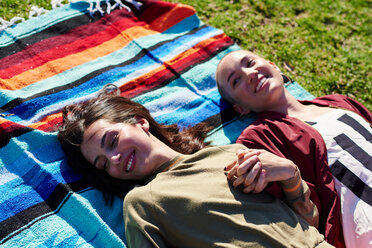 Two young female friends lying on picnic blanket in park, Los Angeles, California, USA - CUF48680
