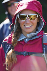 Hikers in hooded jacket and sunglasses - CUF48795