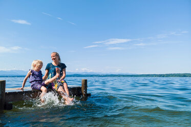 Mutter und Tochter kühlen ihre Füße im Wasser, Starnberger See, Bayern, Deutschland - CUF48822
