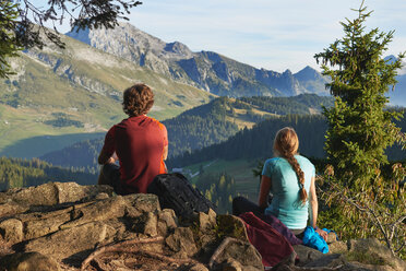 Hikers enjoying view of mountains, Manigod, Rhone-Alpes, France - CUF48867