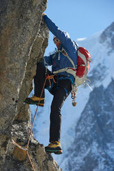Mountaineer using harness for climb, Chamonix, Rhone-Alps, France - CUF48893