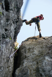 Rock climber jumping over rocks, Chamonix, Rhone-Alps, France - CUF48910