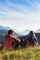 Hikers enjoying view of mountains, Manigod, Rhone-Alpes, France - CUF48921