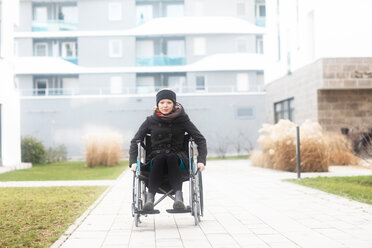 Woman in wheelchair in residential area - CUF48959
