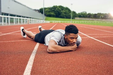 Runner lying on running track - CUF49064