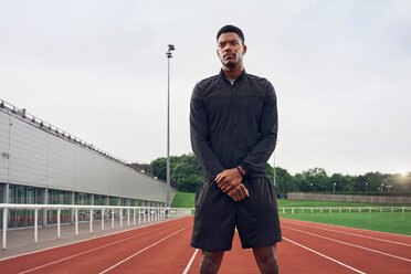 Portrait of athlete on running track - CUF49084