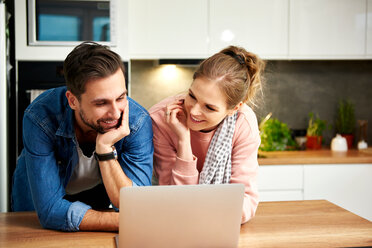 Couple using laptop in kitchen - CUF49131