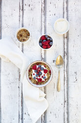 Bowl of muesli with Greek yogurt, popped quinoa, raspberries, blueberries and pomegranate seed - LVF07766