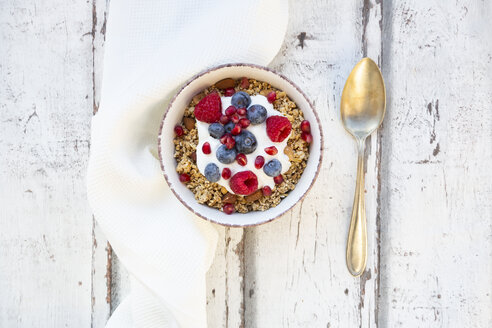 Bowl of muesli with Greek yogurt, popped quinoa, raspberries, blueberries and pomegranate seed - LVF07767