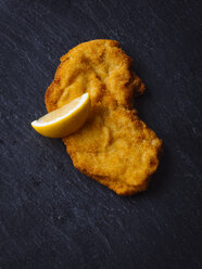 Wiener Schnitzel and lemon slice on slate - PPXF00159