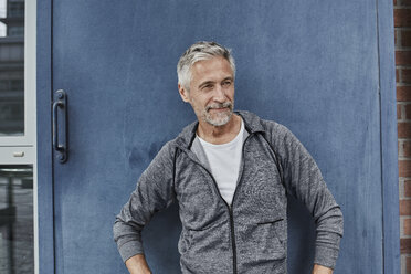 Portrait of mature man wearing tracksuit top in front of gym - RORF01739