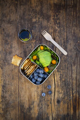 Lunch box of leaf salad, avocado, blueberries, tomatoes and crackers - LVF07777