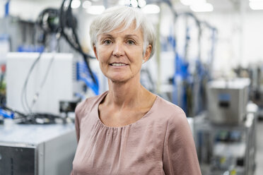 Portrait of confident senior woman in a factory - DIGF05663