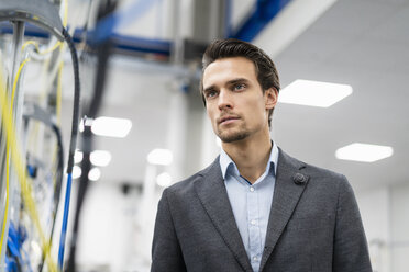 Portrait of confident businessman in a factory - DIGF05667