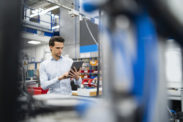 Geschäftsmann mit Tablet in einer Fabrik - DIGF05717