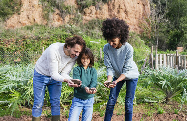 hapy family holding soil in their cupped hands - GEMF02754