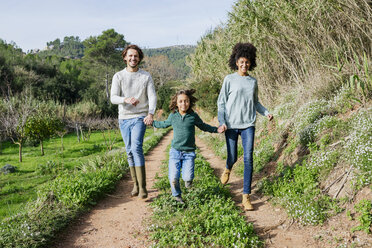 Happy family running in the countryside, holding hands - GEMF02777