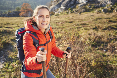 Portrait of smiling woman on a hiking trip in the mountains - BSZF00954