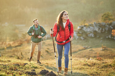 Couple walking on alpine meadow on a hiking trip in the mountains - BSZF00979